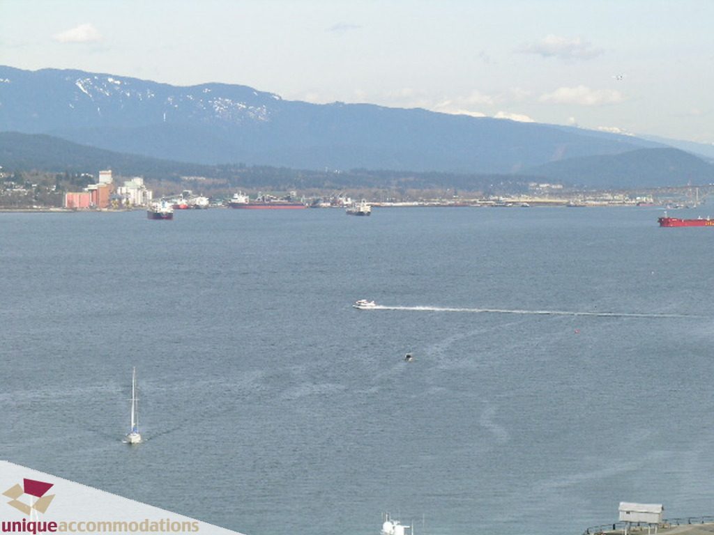 Panoramic city view from 1903 - 535 Nicola Street, featuring a stunning waterfront with boats and mountains in the...
