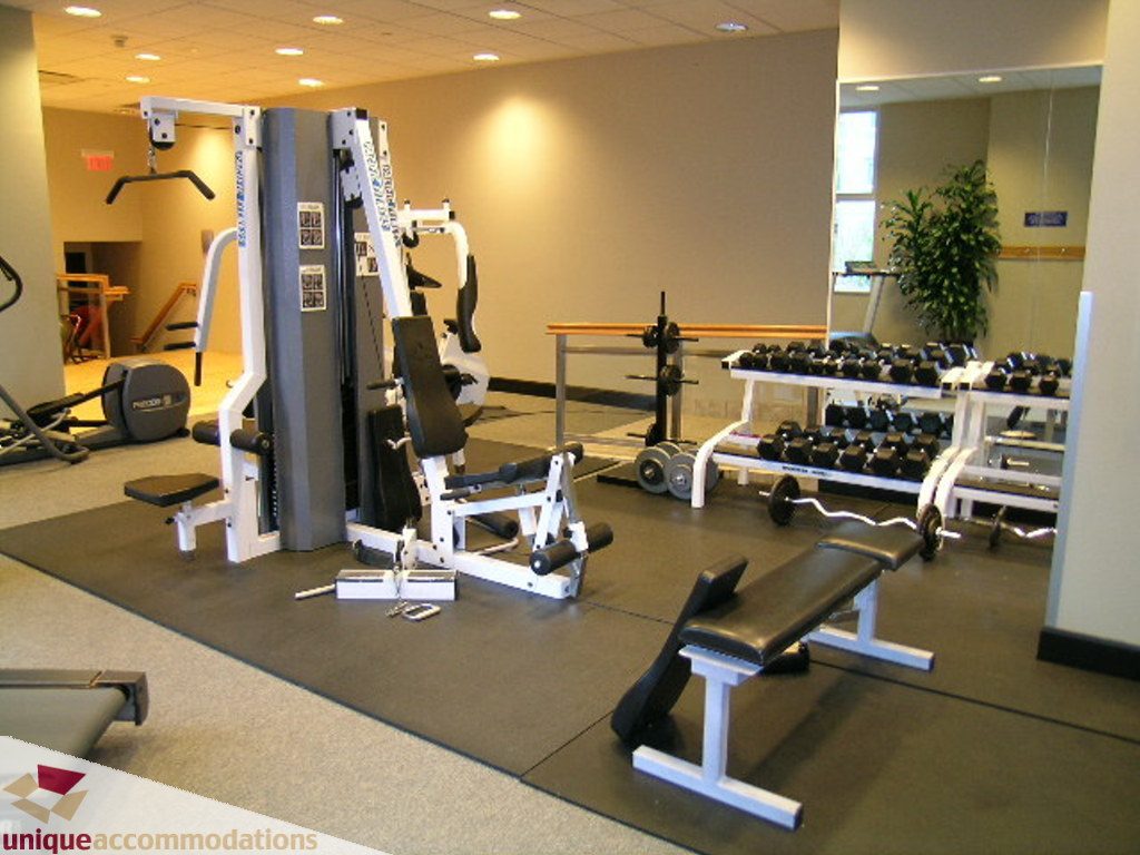 Spacious gym with weight machines and mirrors, perfect for fitness enthusiasts. - 1903 - 535 Nicola Street, Vancouver Downtown