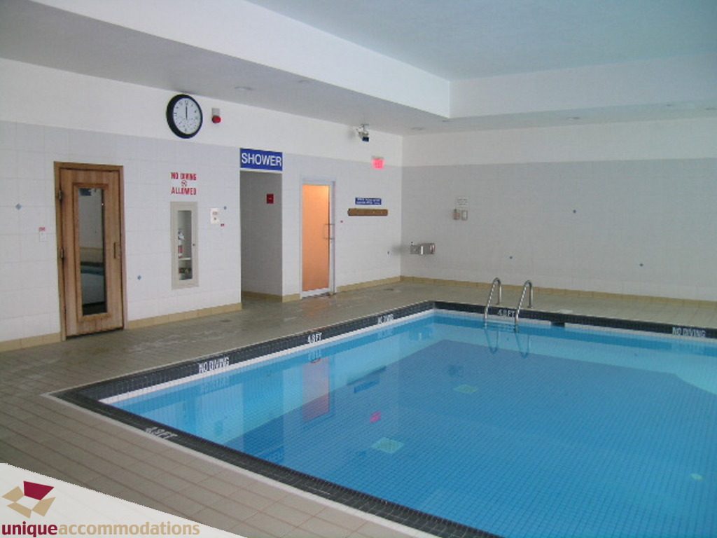 Spacious indoor pool area with tiled walls and floor, perfect for relaxation. - 1903 - 535 Nicola Street, Vancouver Downtown