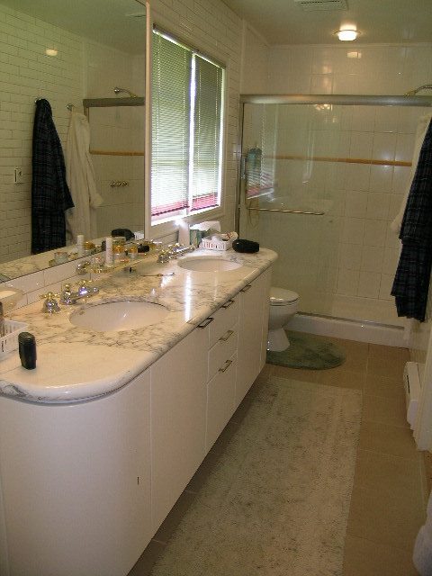 Bright bathroom with marble countertops and a walk-in shower. - 1104 Hillside Road, West Vancouver