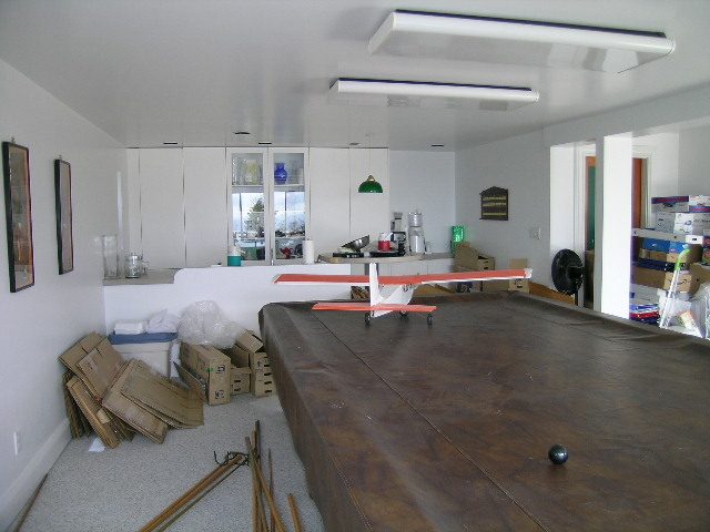 Living room with hardwood floors and scattered boxes, suggesting ongoing move-in or renovation. - 1104 Hillside Road, West Vancouver