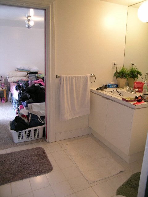 Bathroom with white countertop and towel rack, laundry basket visible. - 1104 Hillside Road, West Vancouver