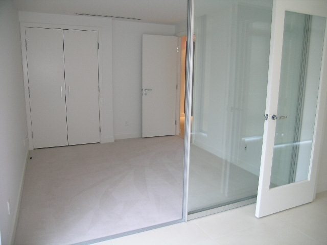 Bright, modern den with glass sliding doors and sleek white cabinetry. - 706 - 1028 Barclay Street, Vancouver Downtown