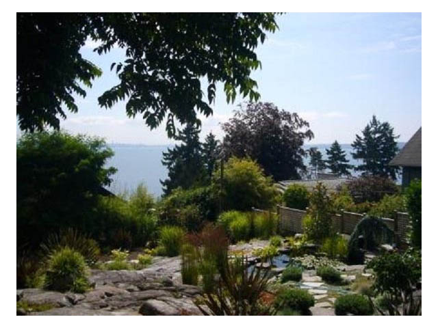 Furnished living room with stone pathway leading to a serene ocean view. - 4750 The Highway, West Vancouver