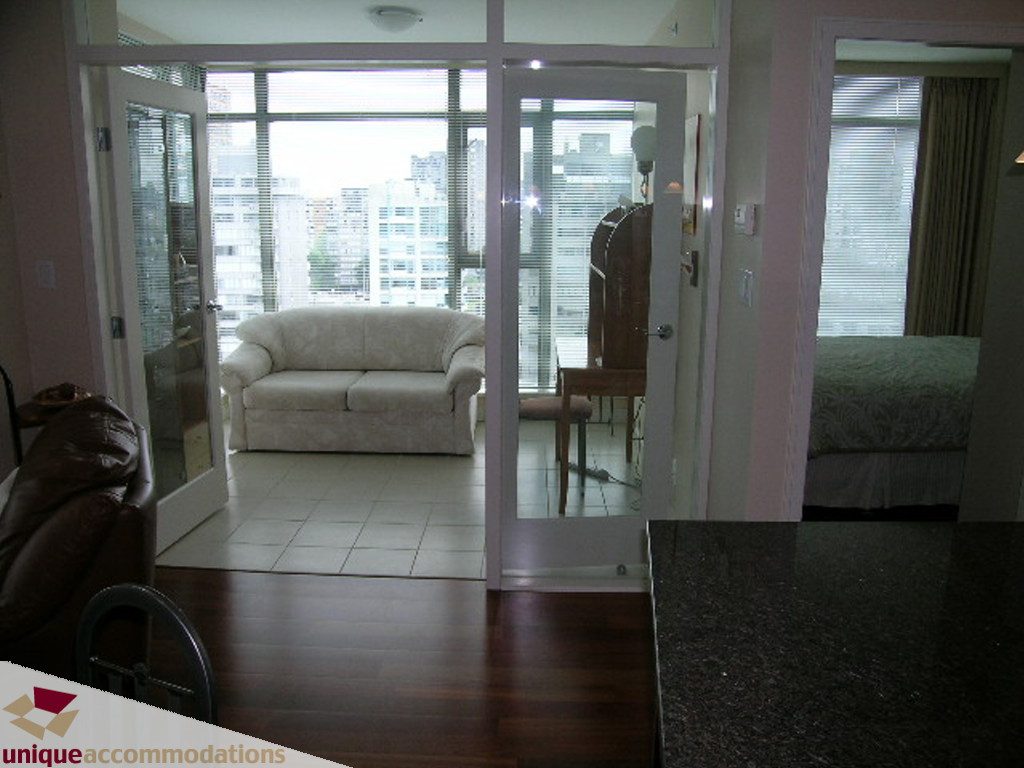 Spacious living room with hardwood floors, city view, and modern furnishings. - 1401 - 1680 Bayshore Drive, Vancouver Downtown