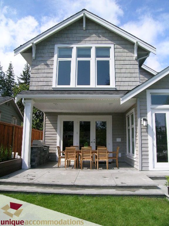 Spacious patio with outdoor dining set and modern siding. - 2015 Lloyd Avenue, North Vancouver