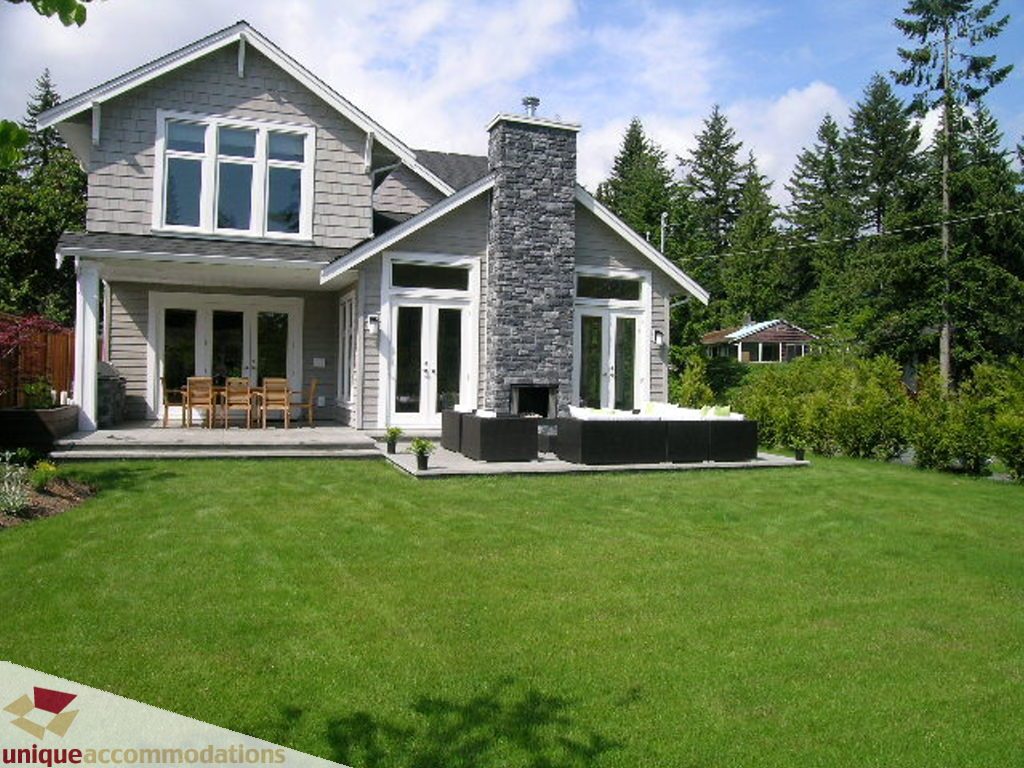 Spacious 4-bedroom + den house with a stone fireplace and large deck overlooking lush greenery. - 2015 Lloyd Avenue, North Vancouver