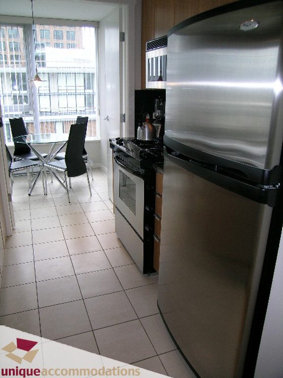 Bright kitchen with stainless steel appliances and city view. - 707 - 1010 Richards Street, Vancouver Downtown