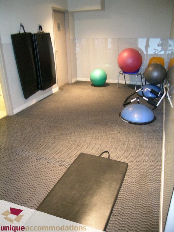 Bright exercise room with yoga mat, stability balls, and storage racks. - 707 - 1010 Richards Street, Vancouver Downtown