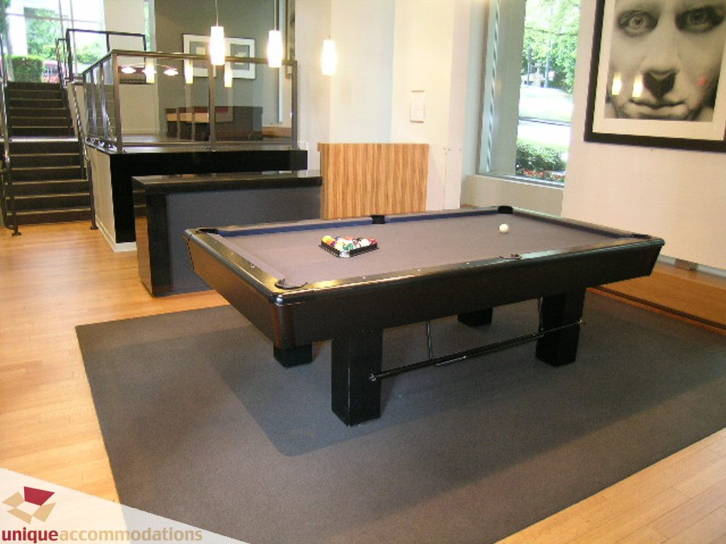 Furnished living room with pool table, hardwood floors, and city view. - 707 - 1010 Richards Street, Vancouver Downtown