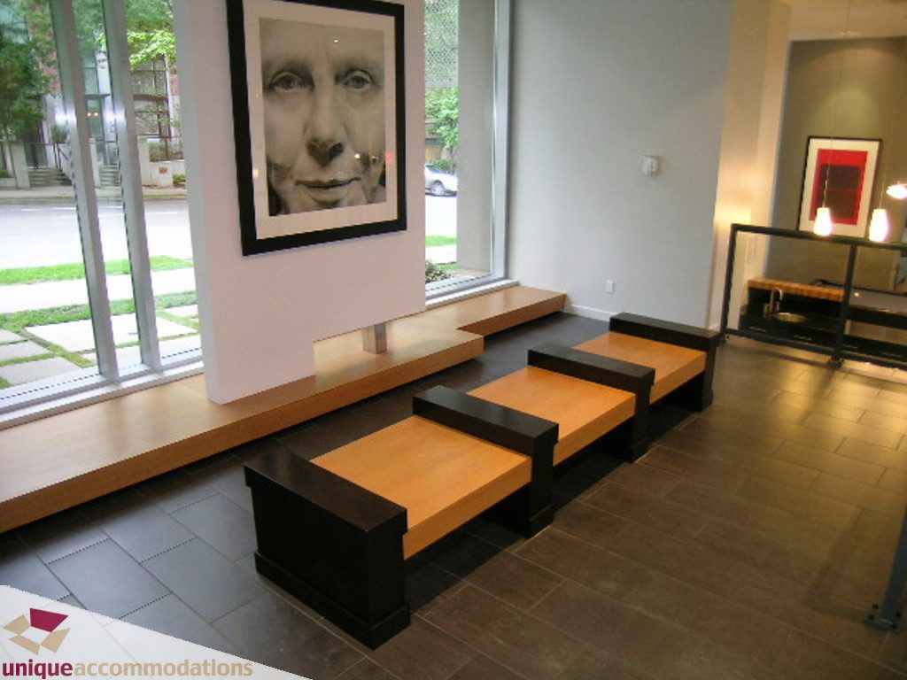 Furnished living room with modern bench seating and large windows. - 707 - 1010 Richards Street, Vancouver Downtown