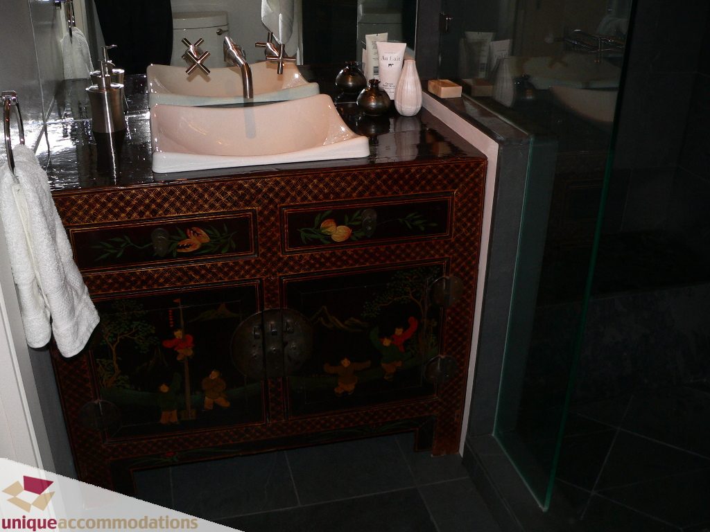 Furnished bathroom with ornate black and gold vanity and modern sink. - 203 - 1066 W 13th Ave, Vancouver West Side