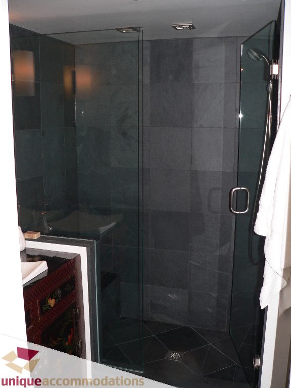 Furnished bathroom with dark slate tiles and glass shower enclosure. - 203 - 1066 W 13th Ave, Vancouver West Side