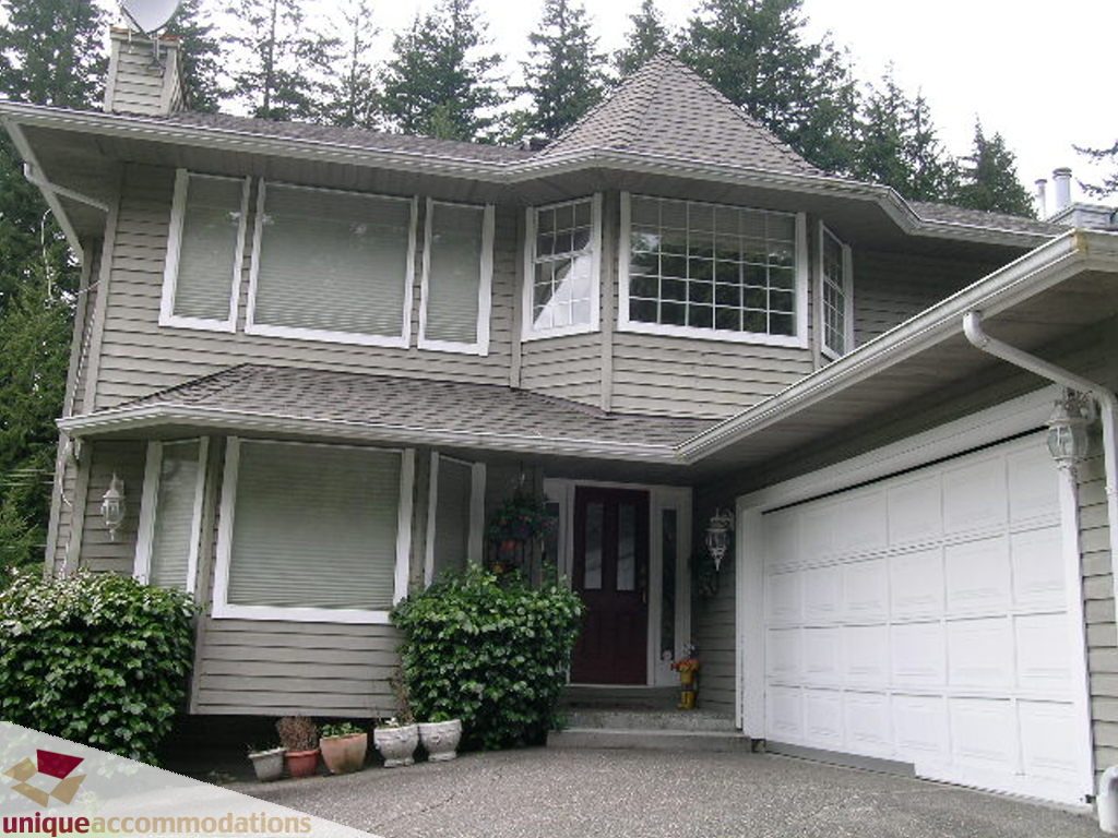 Bright 5-bedroom house with large windows and a cozy front porch. - 5735 Nancy Green way, North Vancouver