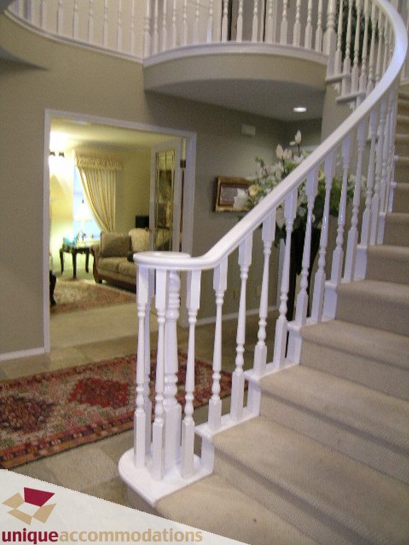 Staircase leading to upper floor with white balusters and carpeted steps. - 5735 Nancy Green way, North Vancouver