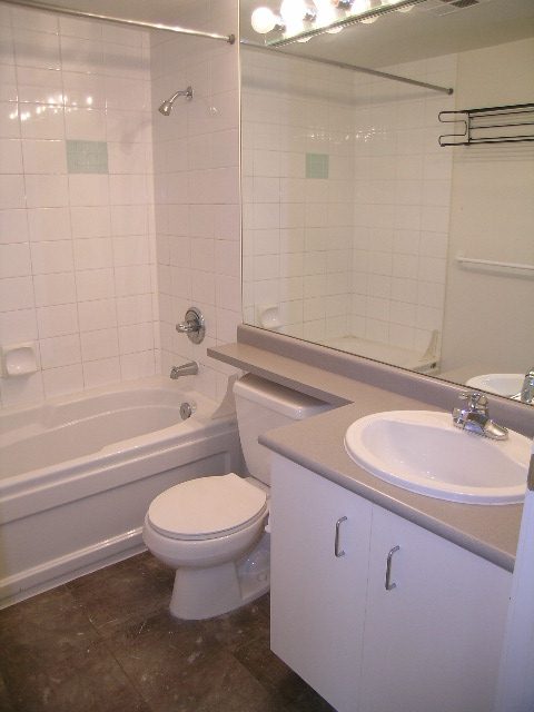Bathroom with white tile, modern sink, and bathtub. - 1401 - 555 Jervis St, Vancouver Downtown