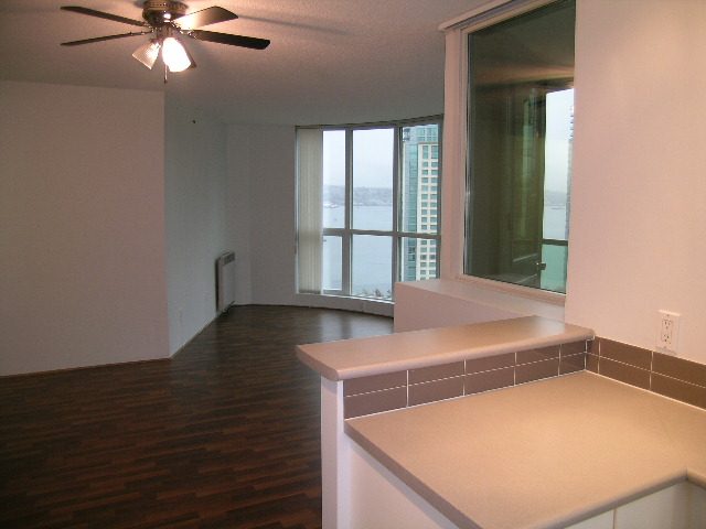 Bright kitchen with hardwood floors, city view, and white countertops. - 2006 - 588 Broughton St, Vancouver Downtown