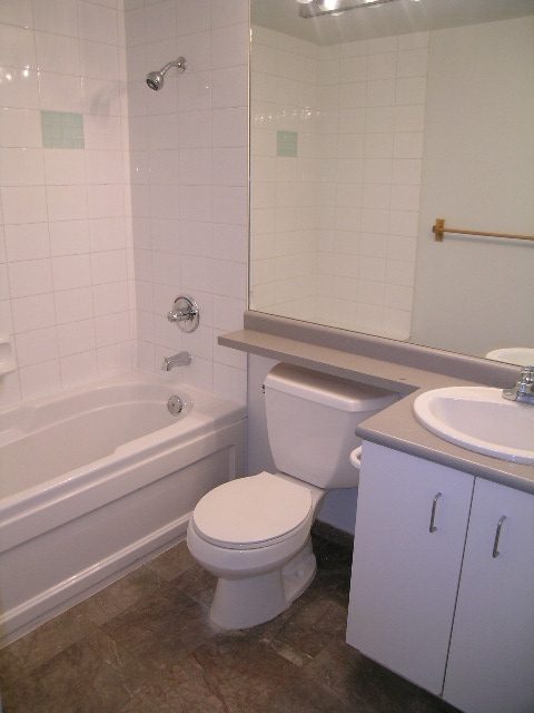 Bright bathroom with white fixtures and a large mirror. - 2006 - 588 Broughton St, Vancouver Downtown