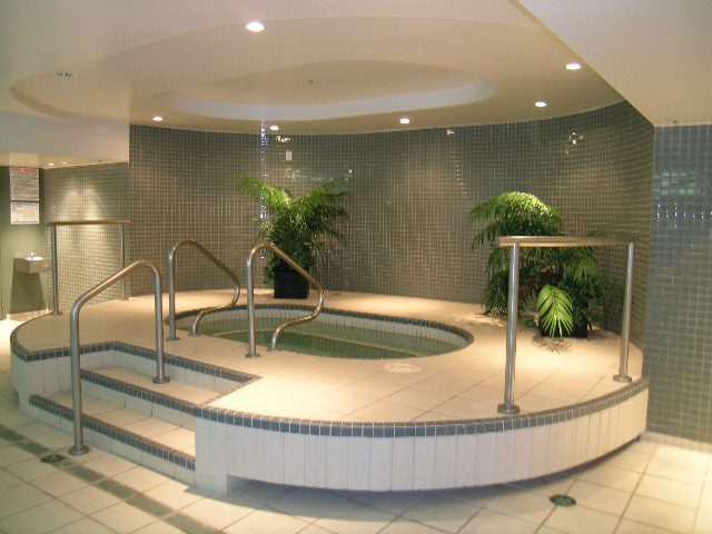 Spacious, modern bathroom with curved tiling and plants. - 2006 - 588 Broughton St, Vancouver Downtown