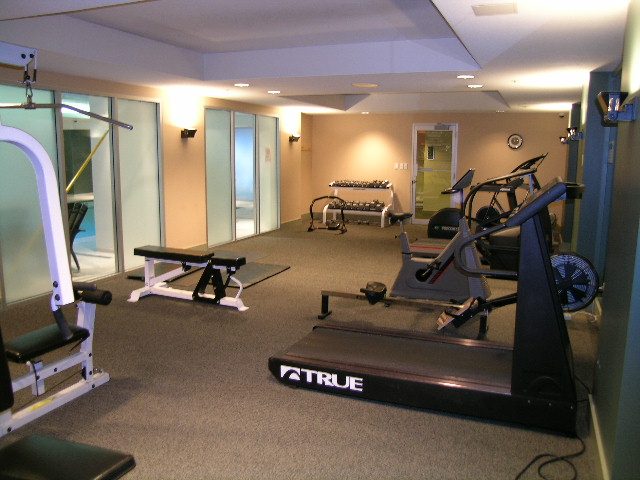 Bright gym with treadmills, weight machines, and mirrors. - 2006 - 588 Broughton St, Vancouver Downtown