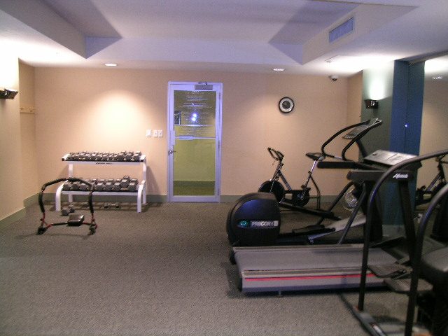 Bright gym with cardio machines and free weights, clean and organized. - 2006 - 588 Broughton St, Vancouver Downtown