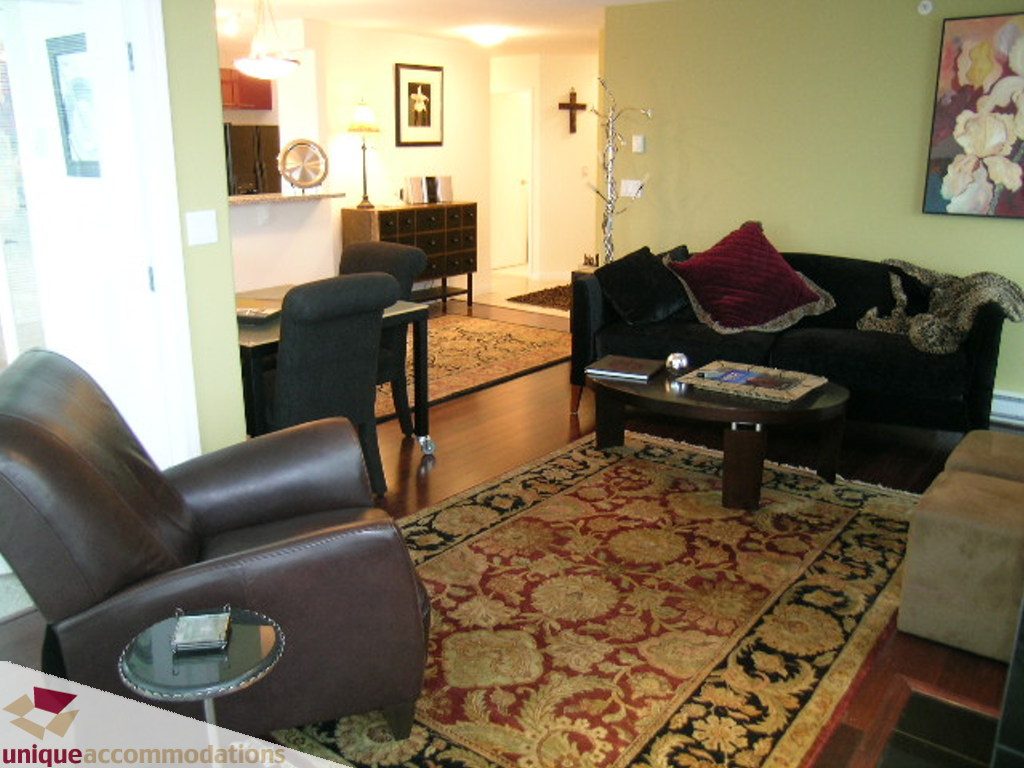 Furnished living room with patterned rug, leather furniture, and wall art. - 2907 - 1328 W Pender St, Vancouver Downtown