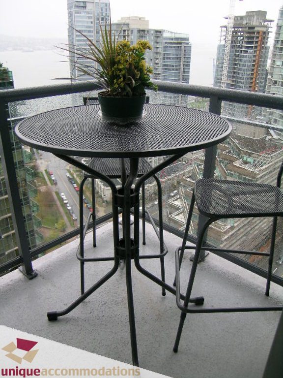 Furnished balcony with city view and modern furniture. - 2907 - 1328 W Pender St, Vancouver Downtown
