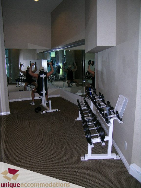 Furnished gym with mirrors, weight racks, and cardio equipment. - 2907 - 1328 W Pender St, Vancouver Downtown