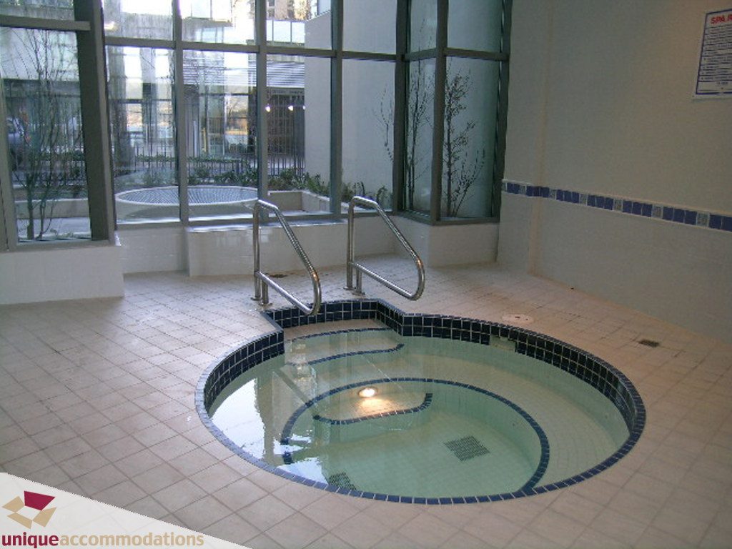 Spacious living room with large windows and a cozy fireplace. - 2907 - 1328 W Pender St, Vancouver Downtown
