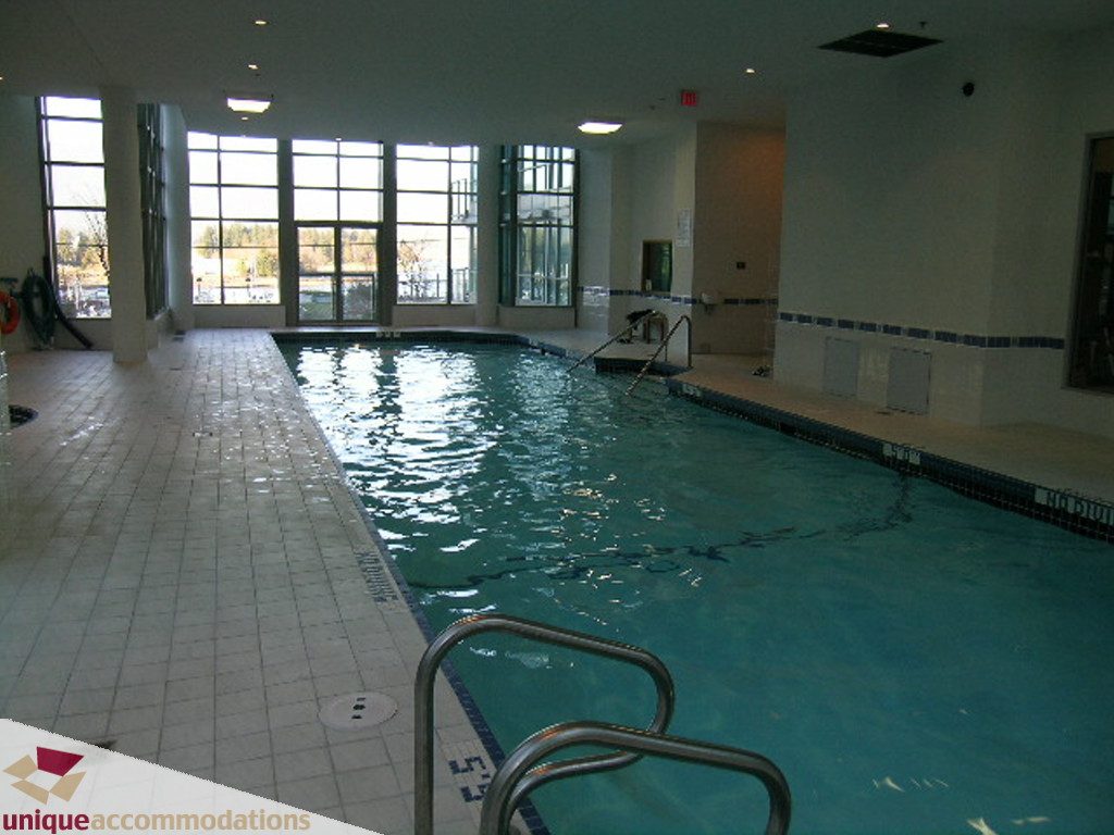 Spacious indoor pool area with large windows and tiled floor. - 2907 - 1328 W Pender St, Vancouver Downtown