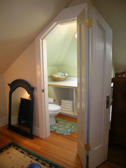 Den with hardwood floors, small rug, and built-in shelving. - 3602 Fromme Rd, North Vancouver