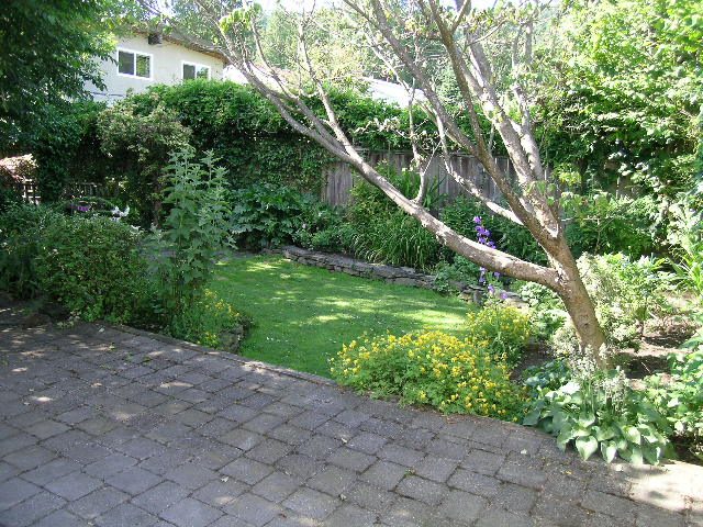 Furnished patio with stone pavers and lush greenery. - 3602 Fromme Rd, North Vancouver