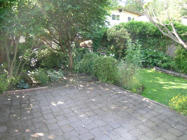 Furnished patio with stone paving and lush greenery surrounding. - 3602 Fromme Rd, North Vancouver