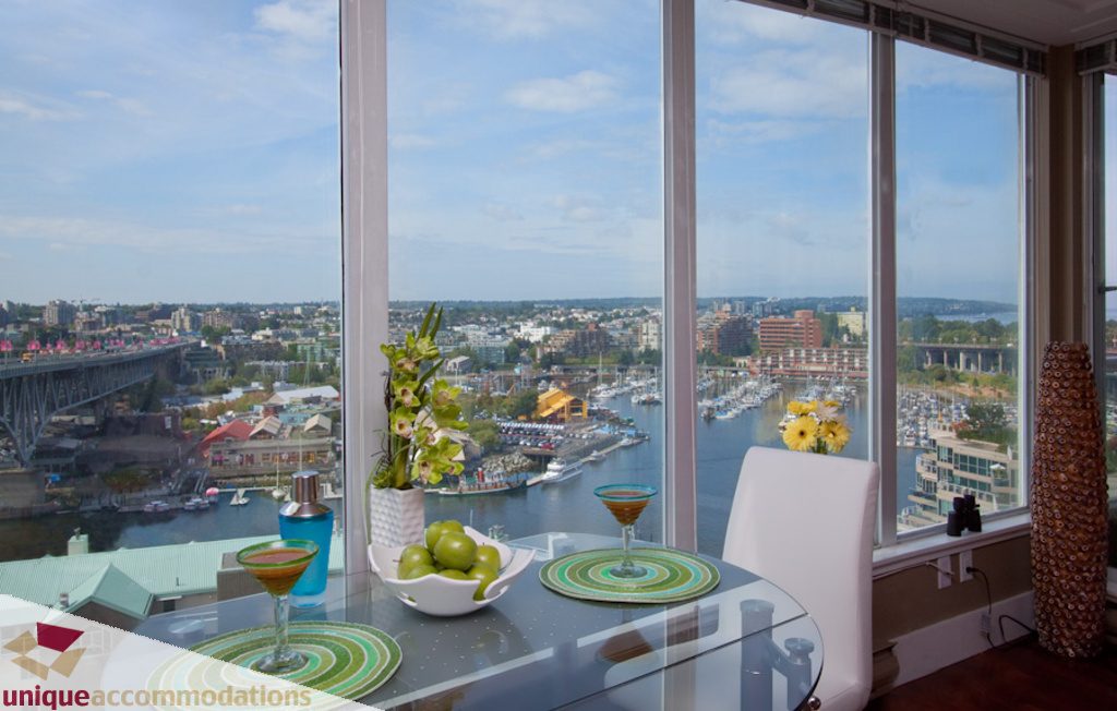 Furnished dining area with city view and modern decor. - 1806 - 1500 Howe St, Vancouver Downtown