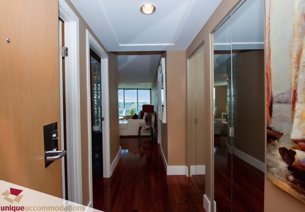 Furnished hallway with hardwood floors and a city view. - 1806 - 1500 Howe St, Vancouver Downtown