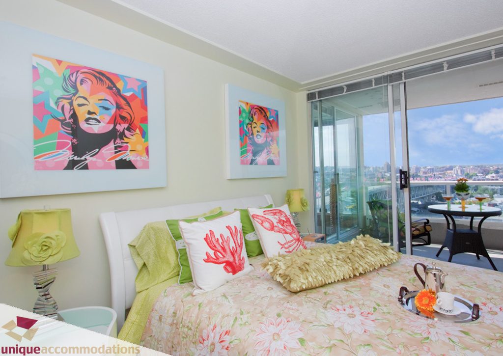 Bright bedroom with colorful Marilyn Monroe artwork and city view. - 1806 - 1500 Howe St, Vancouver Downtown