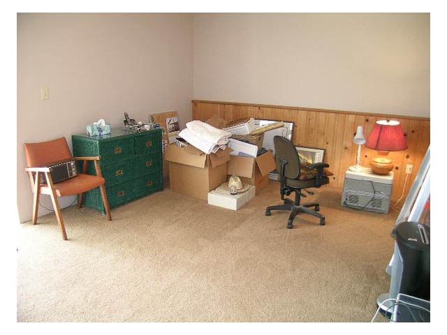 Living room with cluttered furniture and boxes, awaiting move-in. - 3-220 East 4th Street, North Vancouver