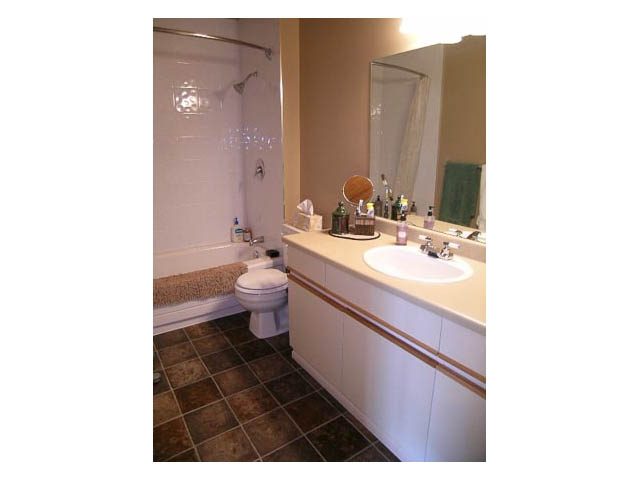 Furnished bathroom with white cabinets, tiled floor, and a shower. - 3-220 East 4th Street, North Vancouver