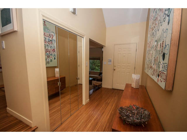 Furnished living room with hardwood floors and mirrored closet doors. - 1882 Whyte Avenue, Vancouver West Side