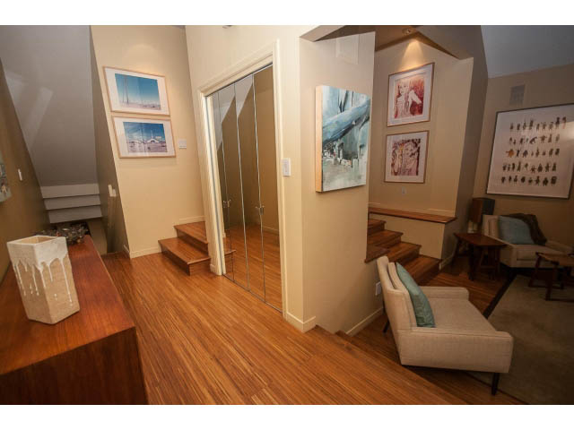 Furnished living room with hardwood floors and modern art. - 1882 Whyte Avenue, Vancouver West Side