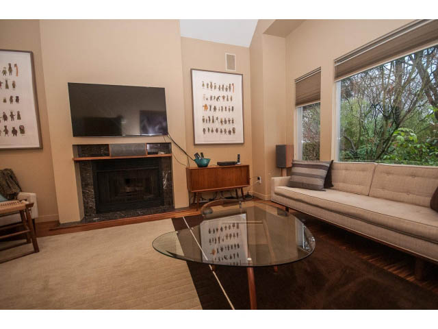 Furnished living room with large window, modern furniture, and wall art. - 1882 Whyte Avenue, Vancouver West Side