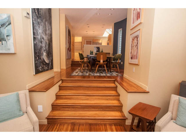 Furnished living area with hardwood floors and a modern kitchen in the background. - 1882 Whyte Avenue, Vancouver West Side
