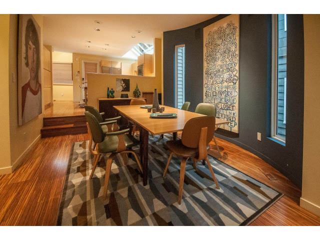 Furnished dining area with wooden table, chairs, and geometric rug. - 1882 Whyte Avenue, Vancouver West Side