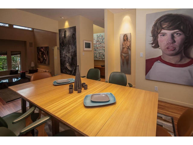 Dining area with wooden table, modern chairs, and artwork on walls. - 1882 Whyte Avenue, Vancouver West Side