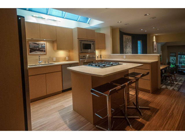 Bright kitchen with modern appliances, hardwood floors, and a city view. - 1882 Whyte Avenue, Vancouver West Side