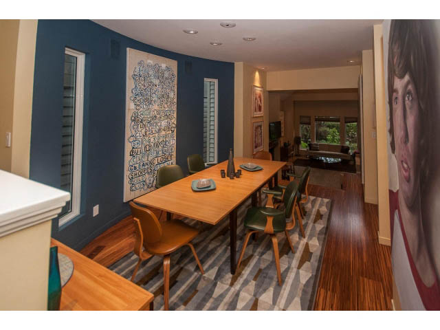 Furnished dining area with wooden tables, chairs, and artwork on walls. - 1882 Whyte Avenue, Vancouver West Side