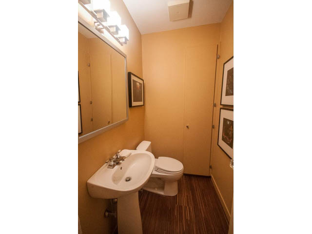 Bright bathroom with wood flooring and a modern sink. - 1882 Whyte Avenue, Vancouver West Side