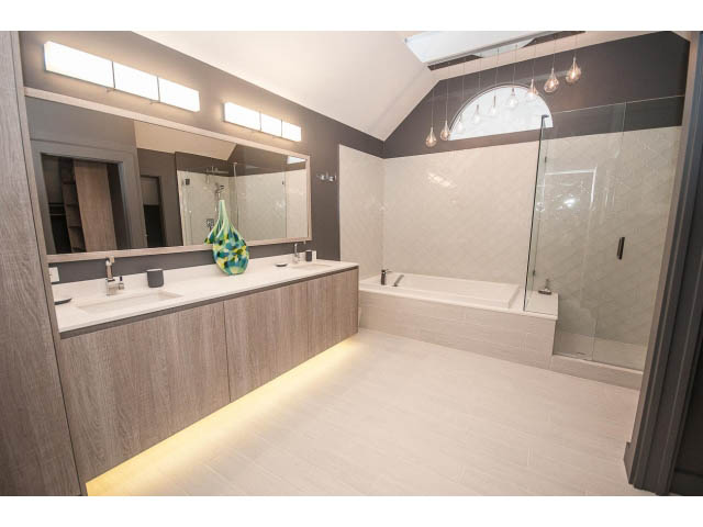 Spacious bathroom with modern vanity, glass shower, and sleek lighting. - 1882 Whyte Avenue, Vancouver West Side