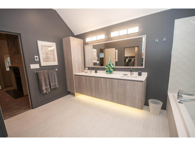 Furnished bathroom with modern vanity, large mirror, and hardwood floors. - 1882 Whyte Avenue, Vancouver West Side