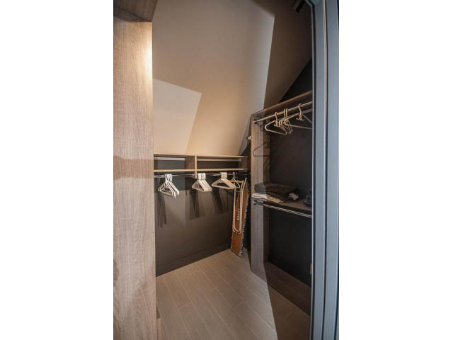 Furnished walk-in closet with hangers and shelves, hardwood floors. - 1882 Whyte Avenue, Vancouver West Side